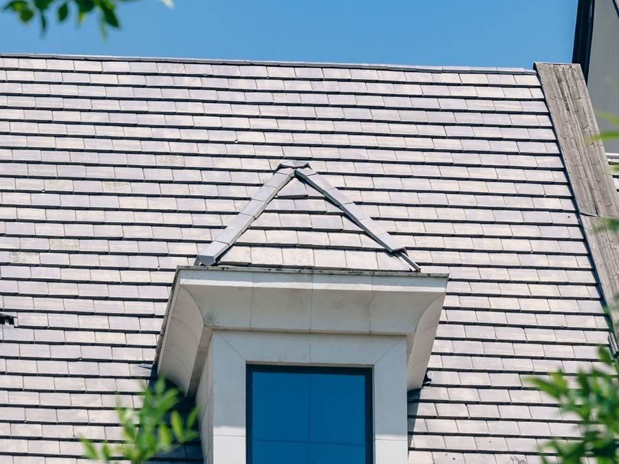 Example after photo: a clean shingle roof with a dormer window